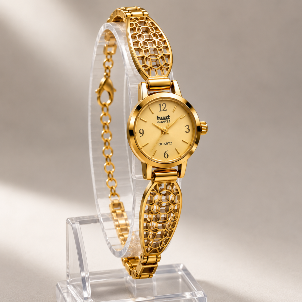 Close up of gold geometric mosaic bracelet watch on display stand
