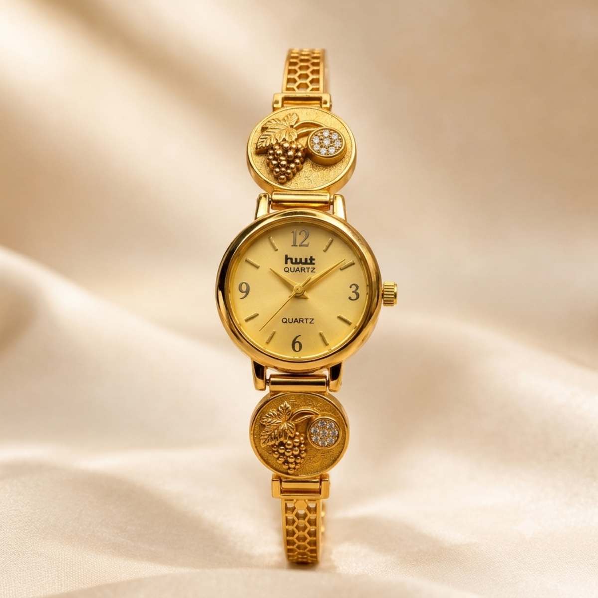 Close up of gold grapevine watch dial with Arabic numerals
