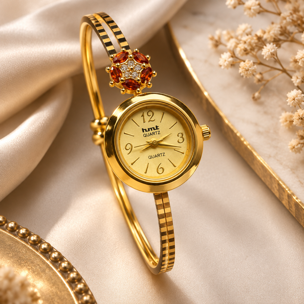 Gold plated garnet flower bangle watch for women - flat lay