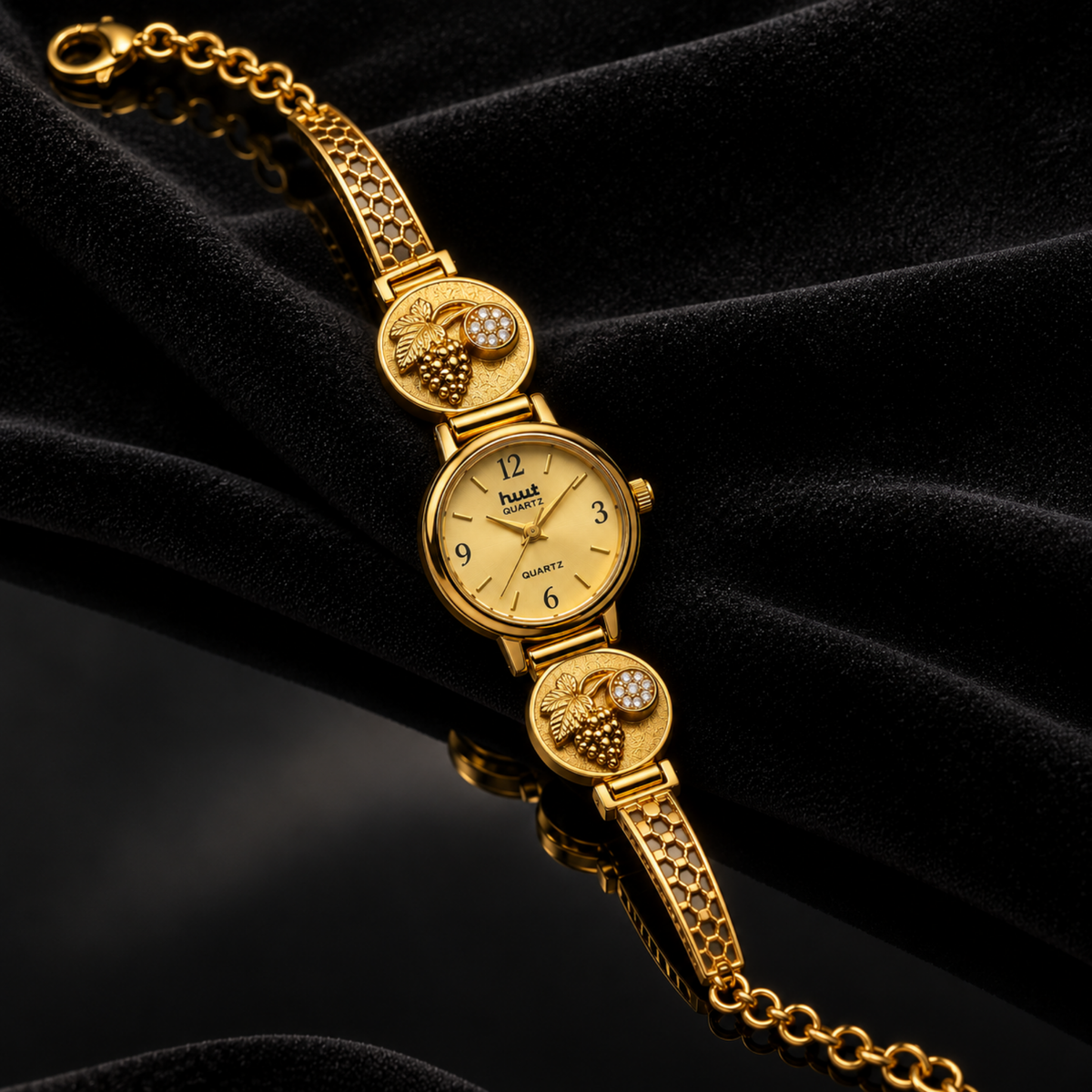 Grapevine leaf medallion with crystal stone accent on gold watch strap