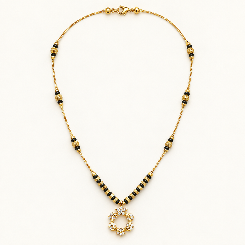 A gold chain necklace with black and gold spacer beads leading to a circular pendant adorned with clear crystals, displayed on a clean white background.