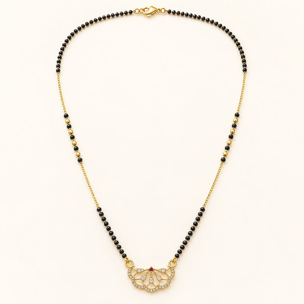 A gold and black beaded necklace with a butterfly-shaped pendant set with clear crystals, displayed on a clean off-white background.