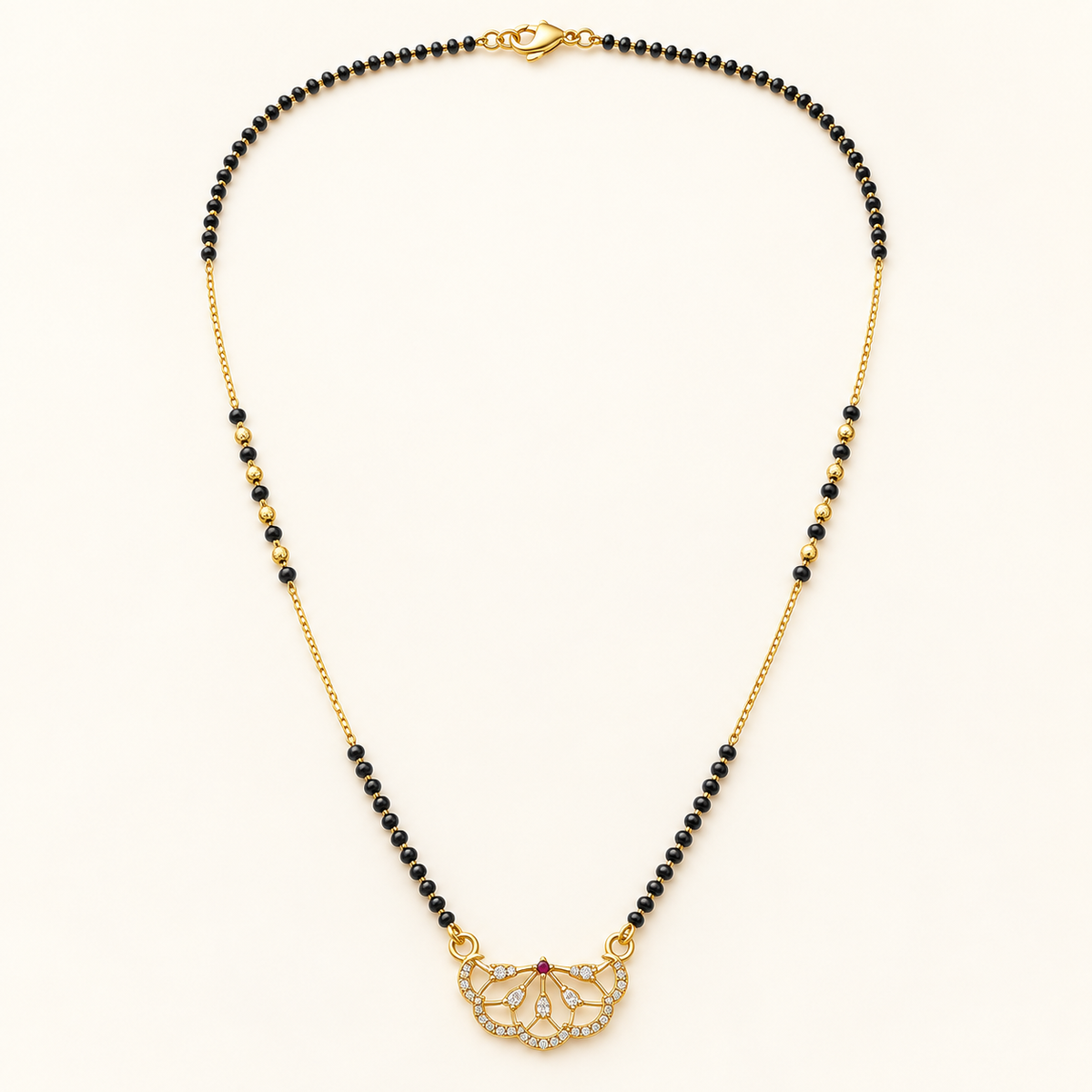 A gold and black beaded necklace with a butterfly-shaped pendant set with clear crystals, displayed on a clean off-white background.