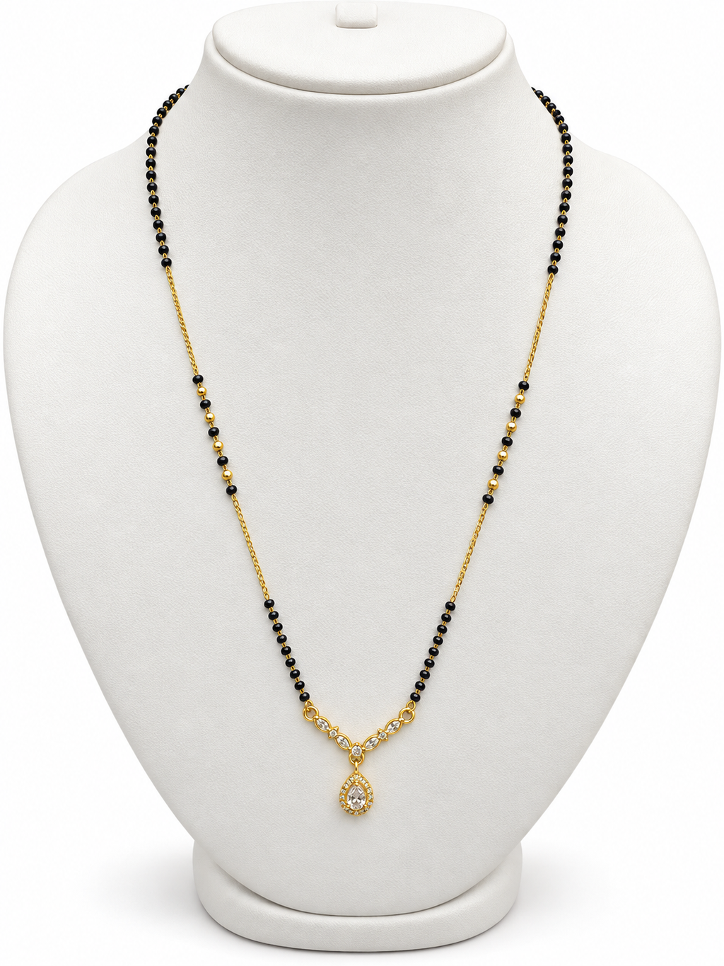 A gold and black beaded necklace with a teardrop-shaped crystal pendant, displayed on a white jewelry bust.