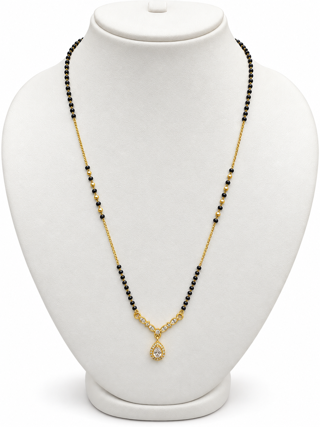 A gold and black beaded necklace with a teardrop-shaped crystal pendant, displayed on a white jewelry bust.