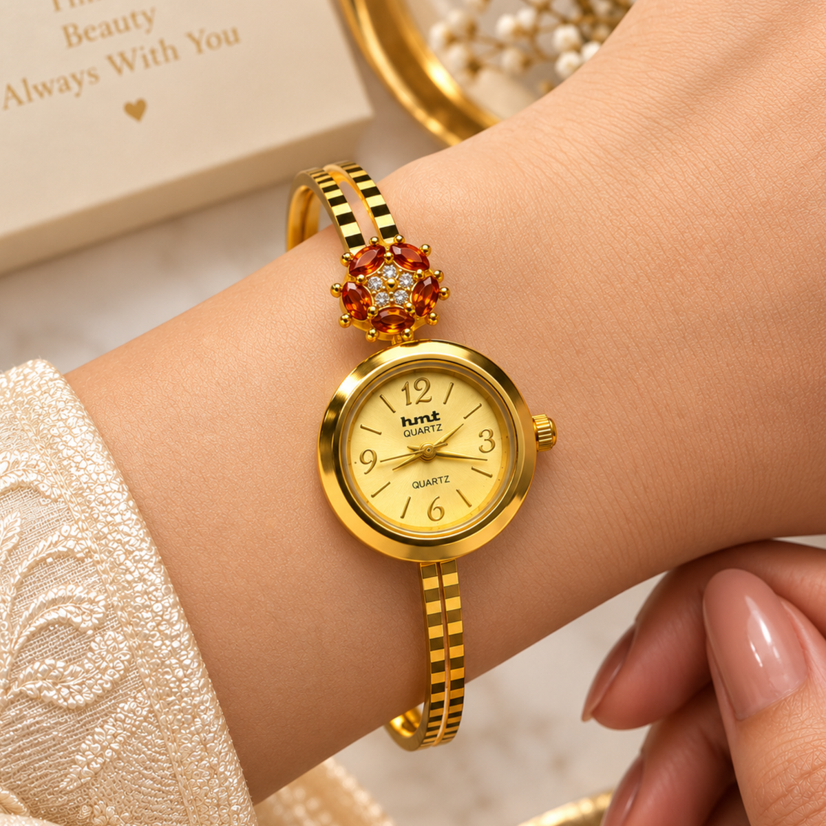 Woman wearing gold garnet flower bangle watch on wrist