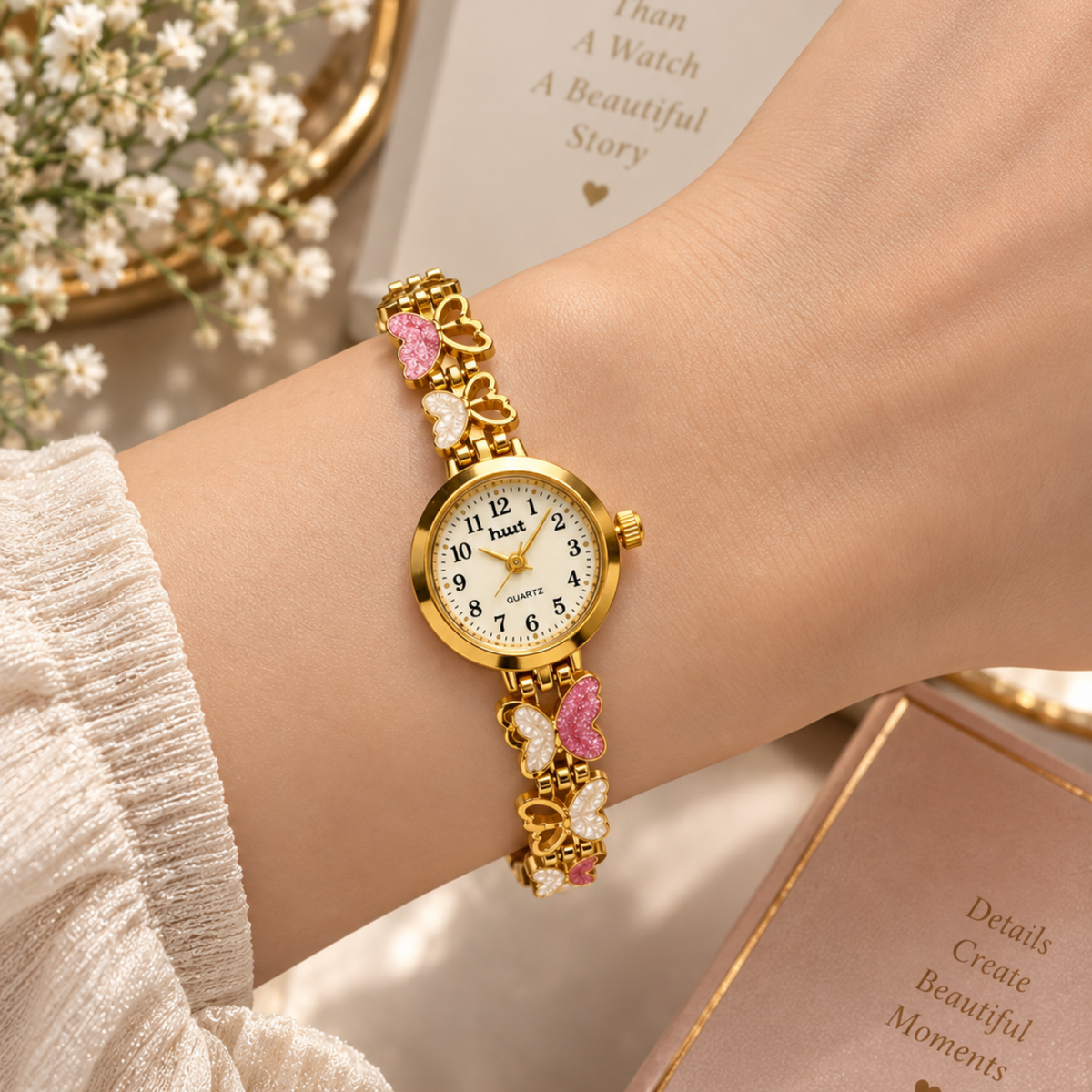 Woman wearing gold plated butterfly charm bracelet watch on wrist