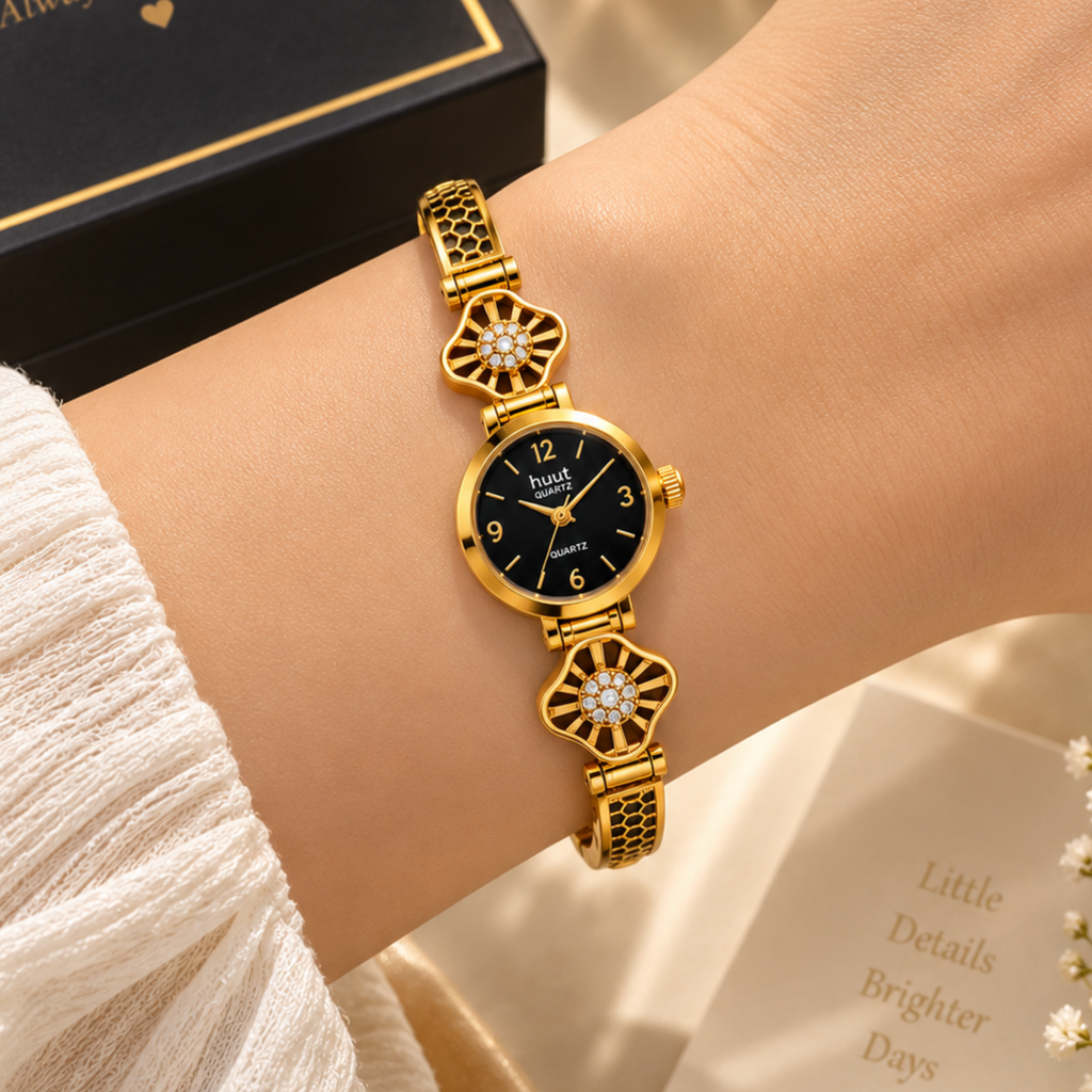 Woman wearing gold starburst crystal bracelet watch black dial